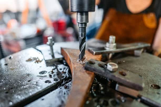 Boring operation enlarging an internal hole in a metal workpiece during lathe machining