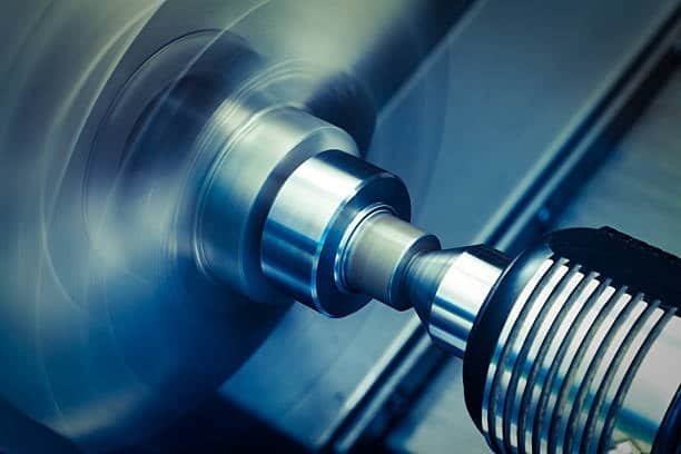 External turning tool in action on a CNC lathe machine creating cylindrical features