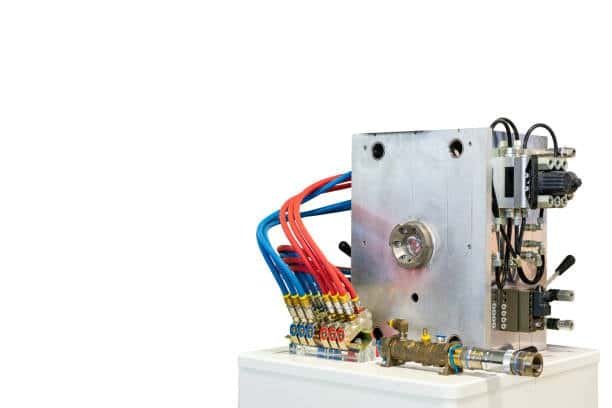 Injection mold featuring hot runner system and multiple colored cooling tubes for precise molding.