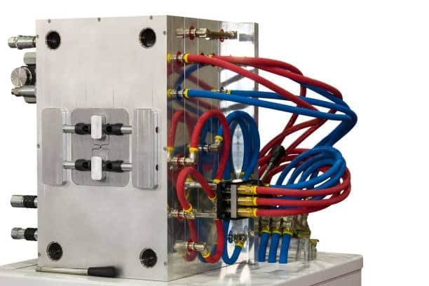 Hot runner manifold system featuring red and blue heating tubes for precise material flow in injection molding.