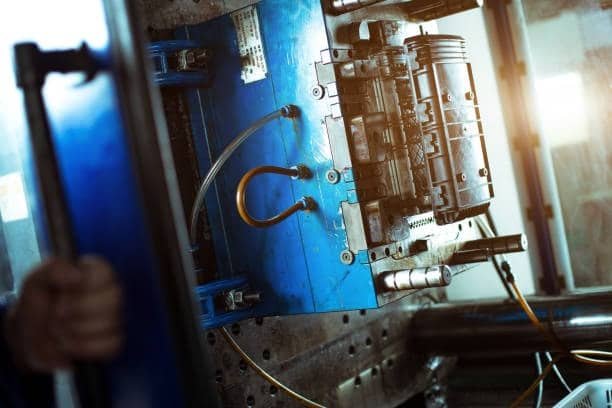 Injection molding machine operating with a blue plastic mold for high-precision part production.