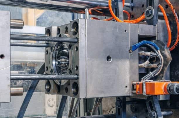Injection molding process showing a mold with a polished core inside the molding machine.