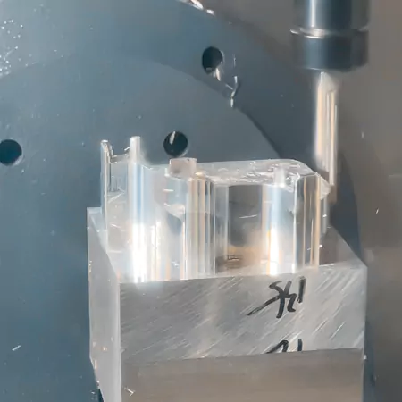 CNC machine engraving fine patterns on a metal workpiece, illustrating versatile engraving on various materials.