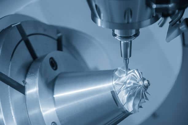 Multi-axis CNC machining creating intricate shapes on a conical metal part