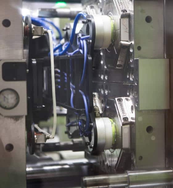 Multi-cavity hot runner mold featuring integrated wiring and connectors for efficient plastic injection molding.