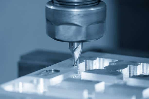 Precision end milling operation carving detailed patterns on a metal workpiece