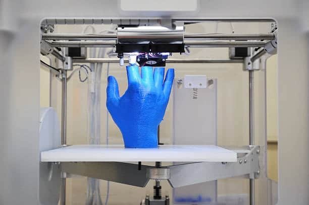 3D printer producing a blue prototype hand for molding validation