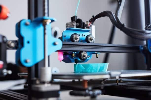 Researchers designing with 3D printer in lab setting