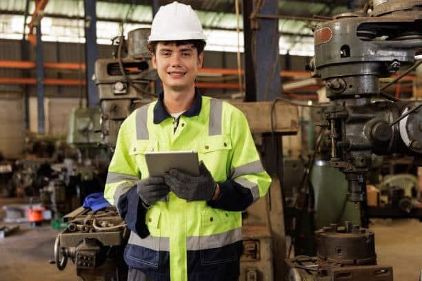 engineer inspecting ABS plastic components in a molding facility