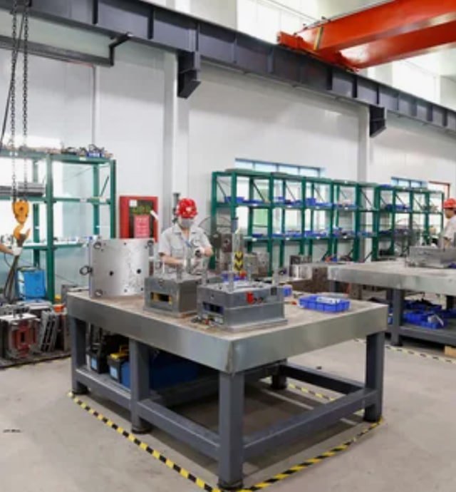 Modern mold workshop featuring advanced milling and EDM equipment, where experienced engineers inspect and assemble precision mold components.