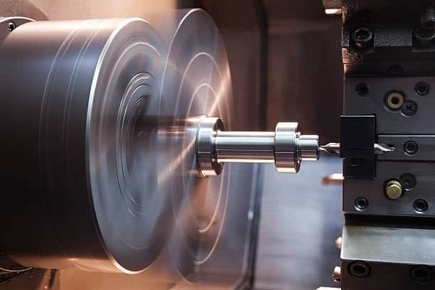 CNC lathe spinning metal part at high RPM for turning operations with precision tooling