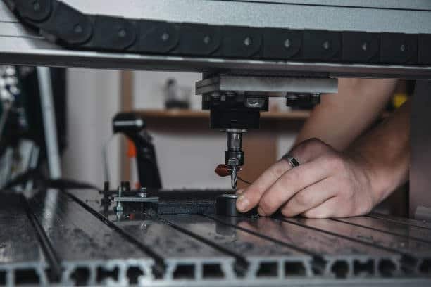 Operator positioning probe tool on a CNC machine to calibrate path for dynamic milling operations