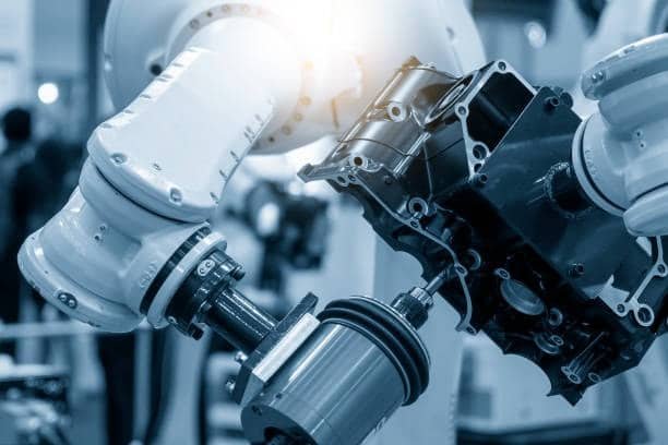 Automated CNC robotic arm gripping and rotating a metal part for multi-axis machining