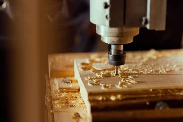Woodworking CNC router machine milling a wooden surface with accurate tool movement