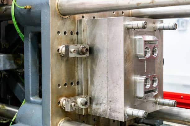 Closeup of mold insert and visible runner gate design in injection molding