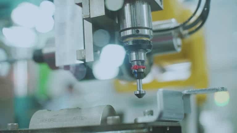 CNC probe measuring surface flatness and finish of machined metal part
