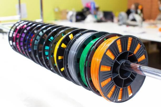 PLA filaments in vibrant shades aligned for injection molding preparation