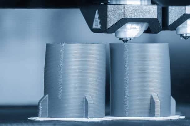 Dual nozzle 3D printer forming two cylindrical mold components