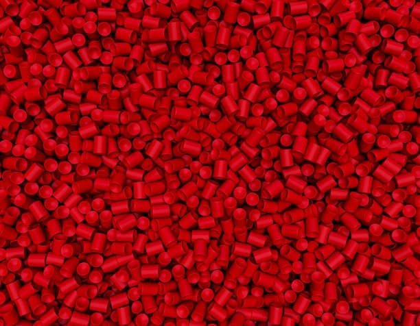 Red and green thermoplastic elastomer pellets representing color flexibility in TPE compounds