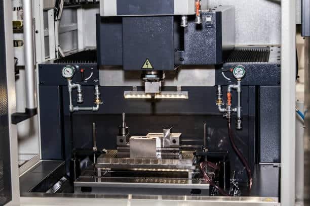 Complete EDM machine setup with control panel and dielectric tank