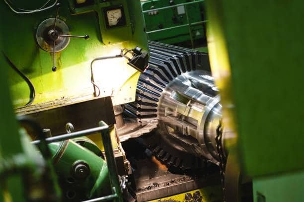 Rotating gear blank being machined with a dynamic milling setup inside an industrial CNC station