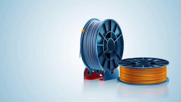 Blue and orange PLA filament spools displayed for injection molding use