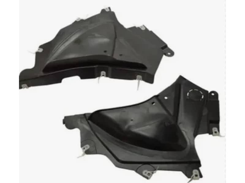 Injection-molded black plastic automotive interior trim components with mounting clips attached.