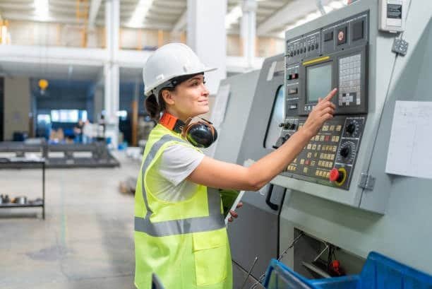 Operator using CNC machinery to process parts made from machine grade ABS plastic