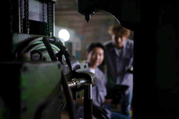 Manual milling machine with operator inspecting machining setup