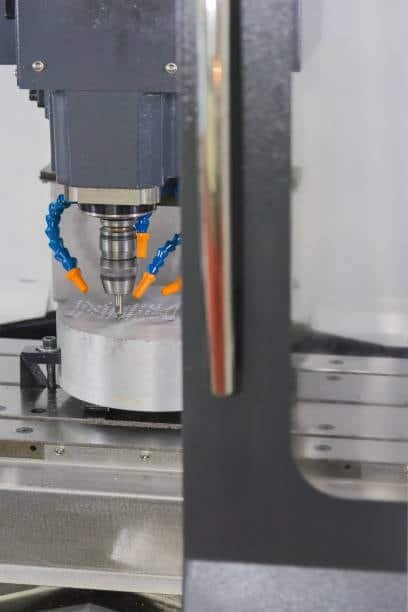 CNC mill engraving aluminum workpiece using 4-axis configuration with rotary control