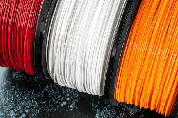 Close-up view of red white and green PLA filaments for injection molding