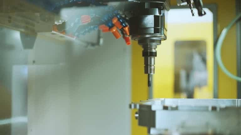 Precision CNC milling head executing dynamic toolpath with multiple coolant lines and high-speed tool rotation