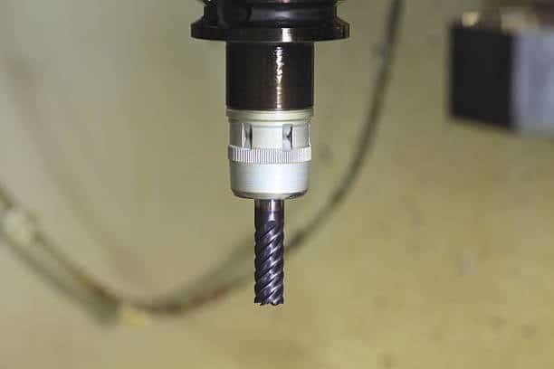 CNC spindle holding a spiral flute end mill for metal milling