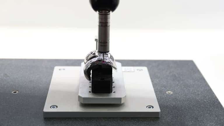 Measuring a curved titanium CNC component using a coordinate measuring machine