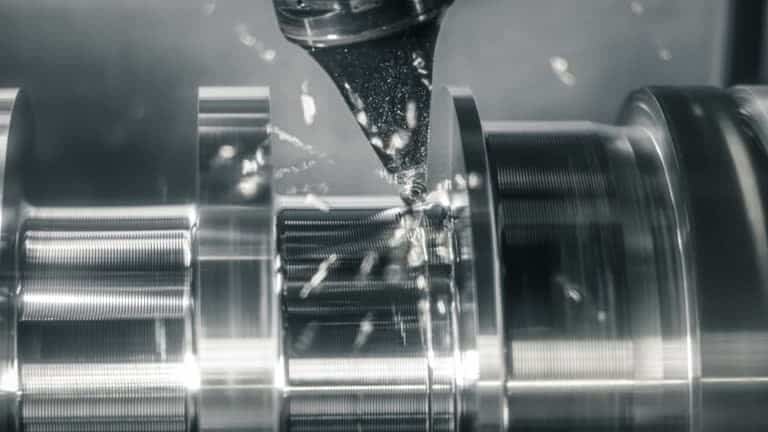 lathe turning ABS plastic shaft with cutting tool and metal chips