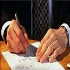 A person signing an NDA (Non-Disclosure Agreement) to ensure the protection of intellectual property during the project development process.