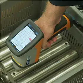 Using a handheld spectrometer to analyze the composition of high-quality steel, ensuring premium material standards for mold production.