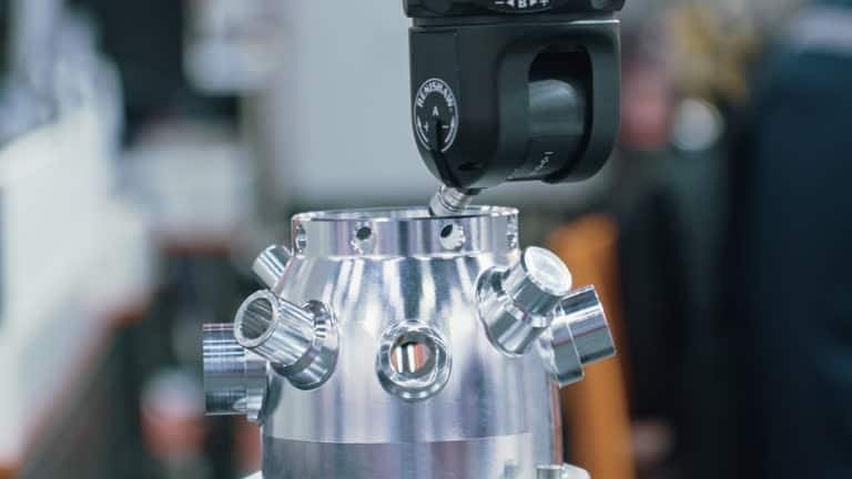 Coordinate measuring machine (CMM) scanning a precision-machined ABS plastic component