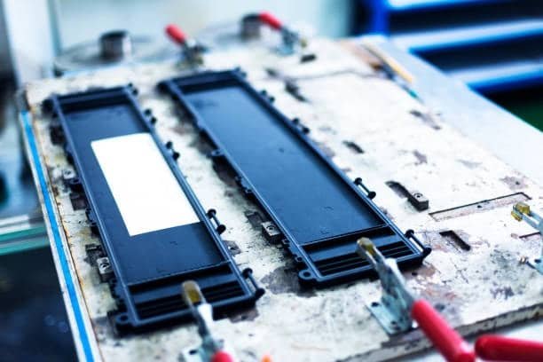 ABS plastic parts placed in injection mold during production process
