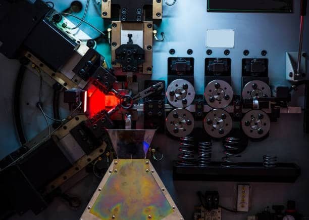Automated spring manufacturing system used alongside ABS injection molding process