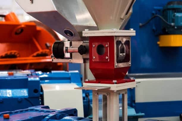 ABS plastic granules loaded through hopper into injection molding machine