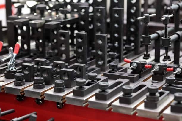 A full CNC fixture kit with clamps and stoppers for multi-component machining setups
