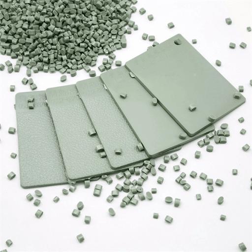 Green ASA plastic color samples with pellets for outdoor durability.