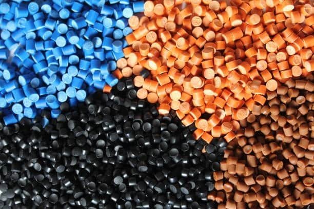 Mix of blue, orange, black, and brown ASA plastic pellets.