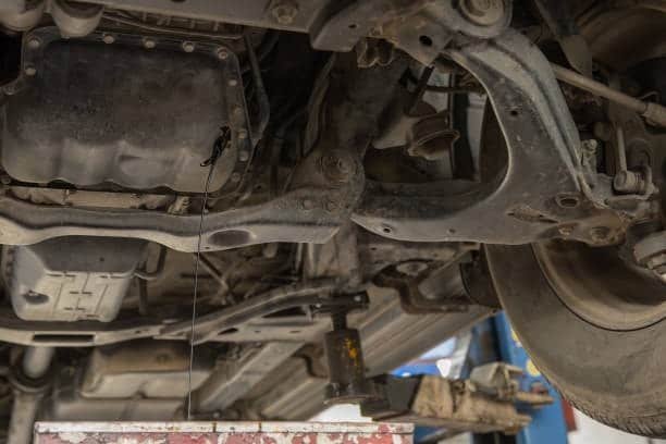 Undercarriage of a vehicle showing suspension system supported by testing fixture