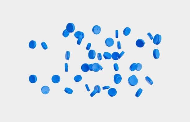 Floating blue BPA-free TPE pellets used in food-safe and non-toxic applications.