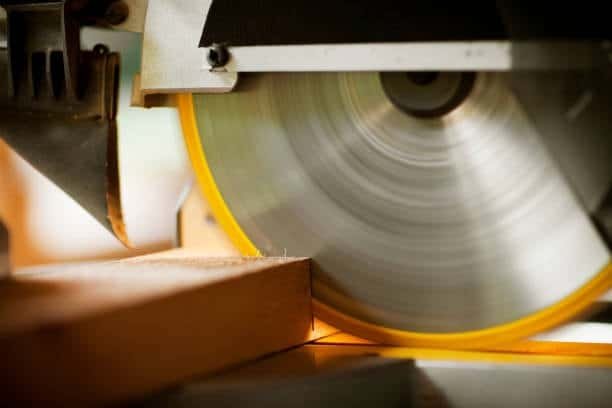 Close-up of circular saw blade cutting through a wooden board with precision