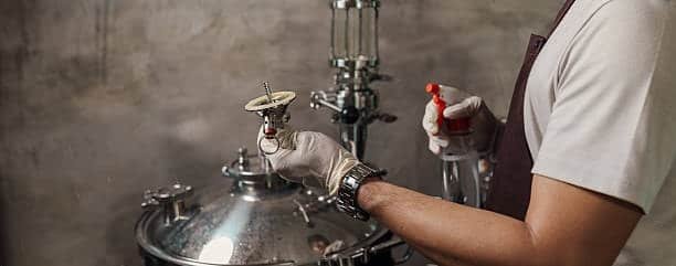 Assembly of miniature industrial valve parts under controlled conditions