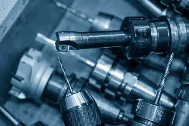 Assorted CNC drilling tools and holders in a manufacturing toolbox