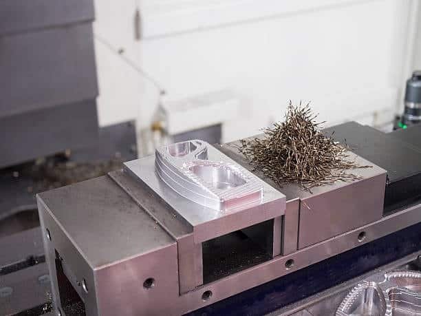 Aluminum machined part with burrs after milling on CNC machine